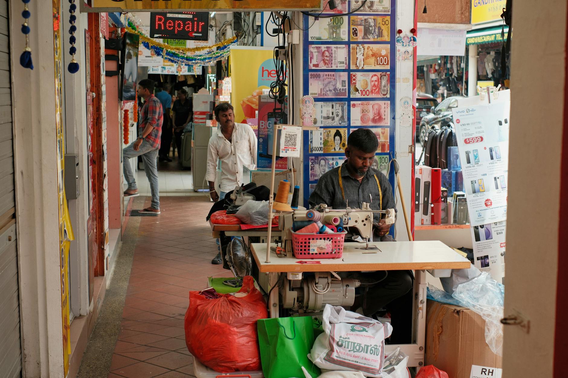 street tailor working in bustling market
